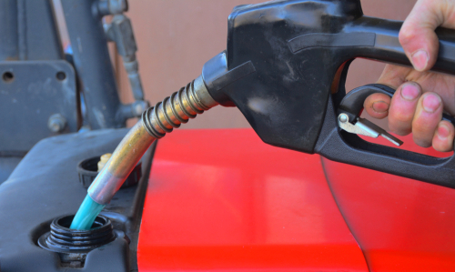 Close-up of refueling a tractor, illustrating reduced fuel consumption achieved by using autosteer technology for optimized field operations.